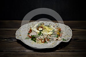 A plate with fresh chicken and salad tortilla wraps Ã‘â€Â 